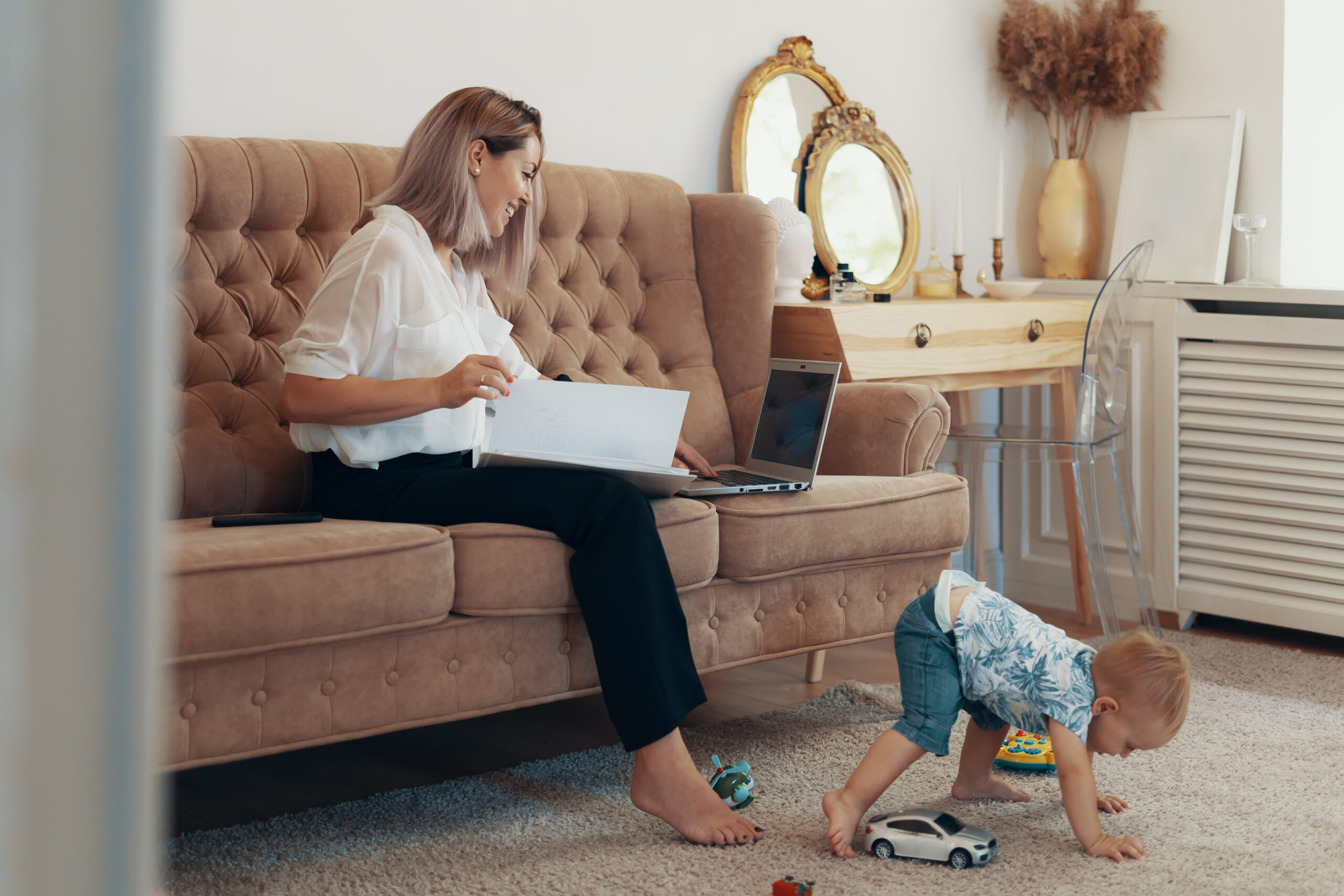 Beautiful business woman working at home. Multi-tasking, freelance and motherhood concept. Working mother career
